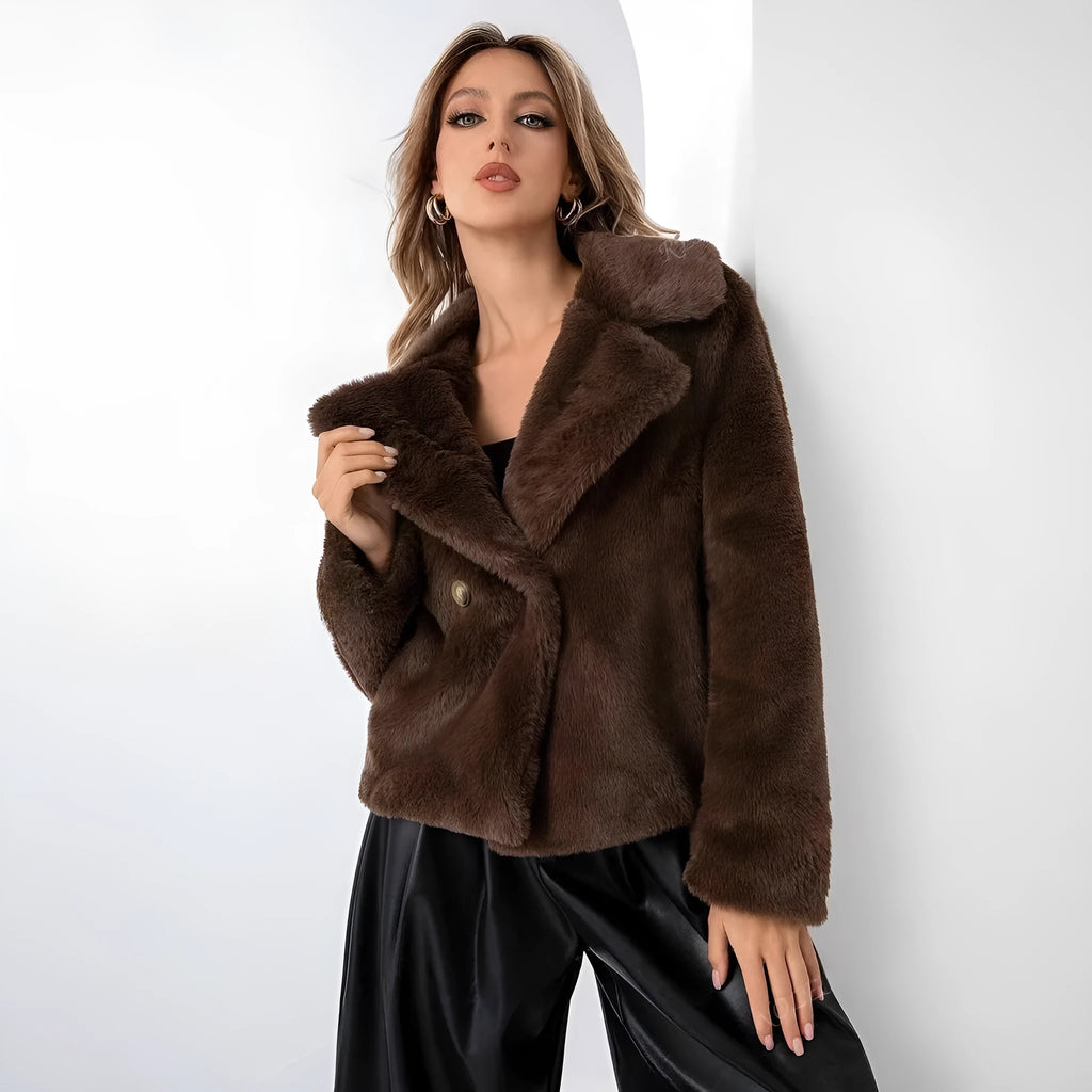 Women's short loose faux fur coat in rose red colour on a hanger.