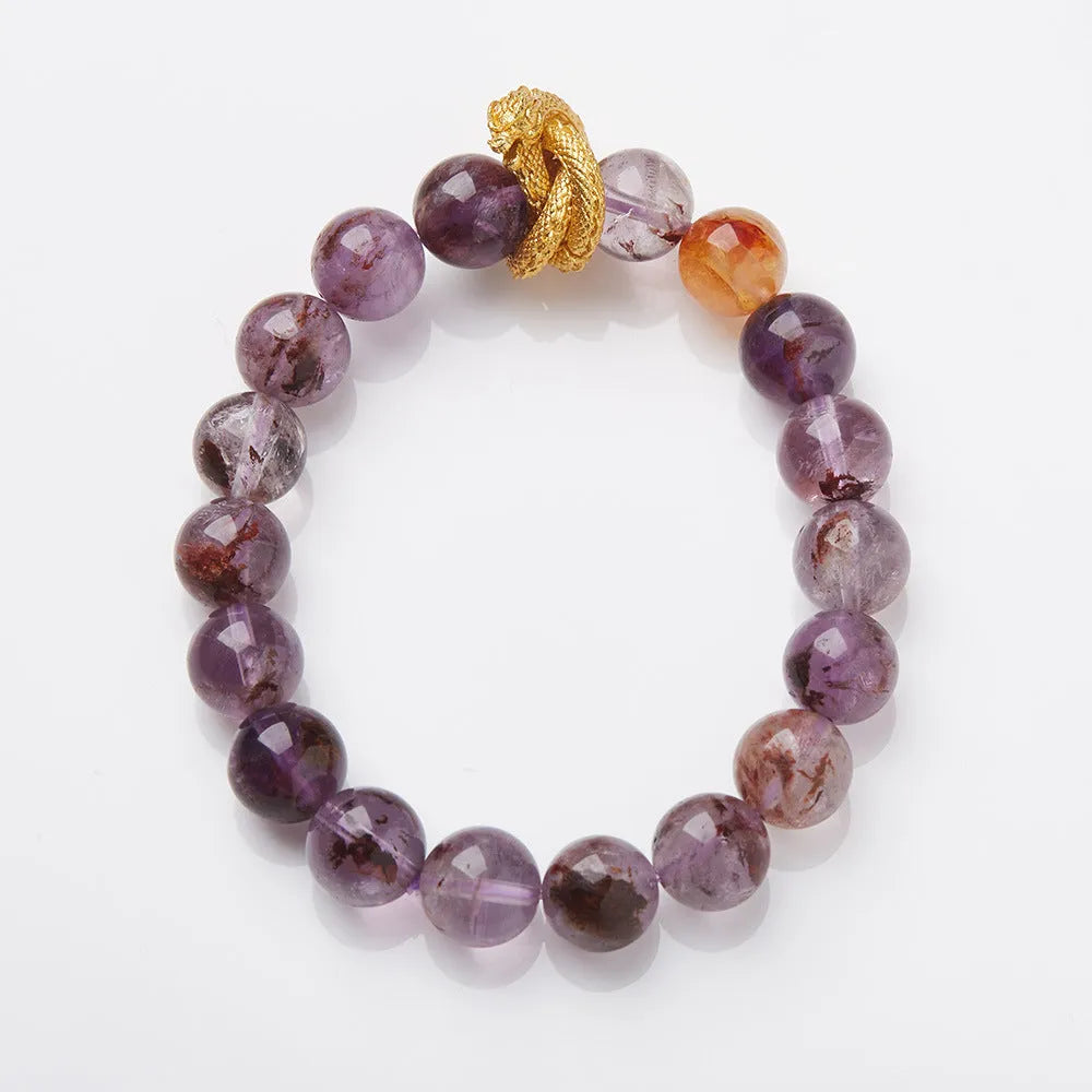 Purple cornucopia crystal bracelet with nine purple lucky charms on wrist