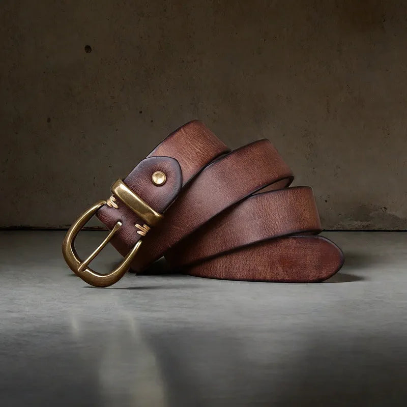 Men's casual leather belt in black with a copper pin buckle on a jeans background