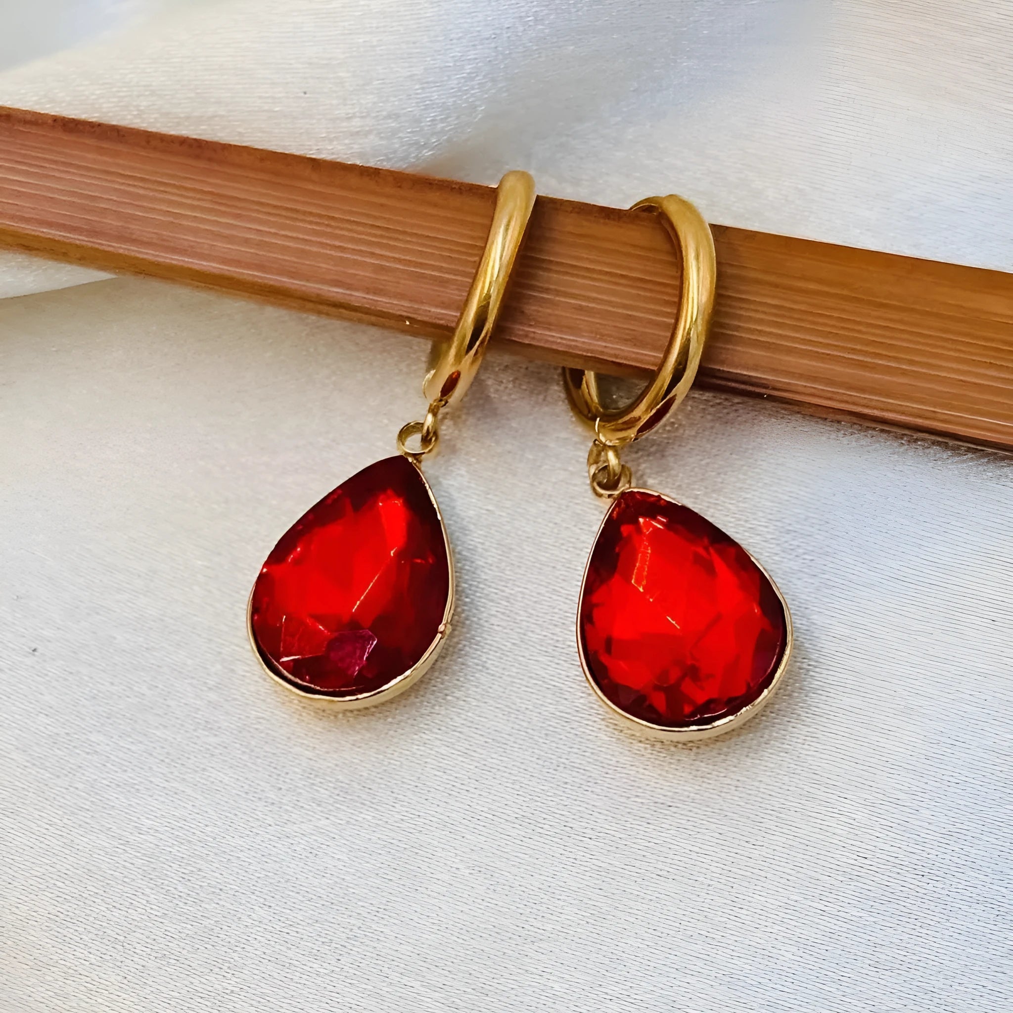 Geometric water drop earrings with carved Saturn design on rare earth glass stone in multiple colour options.