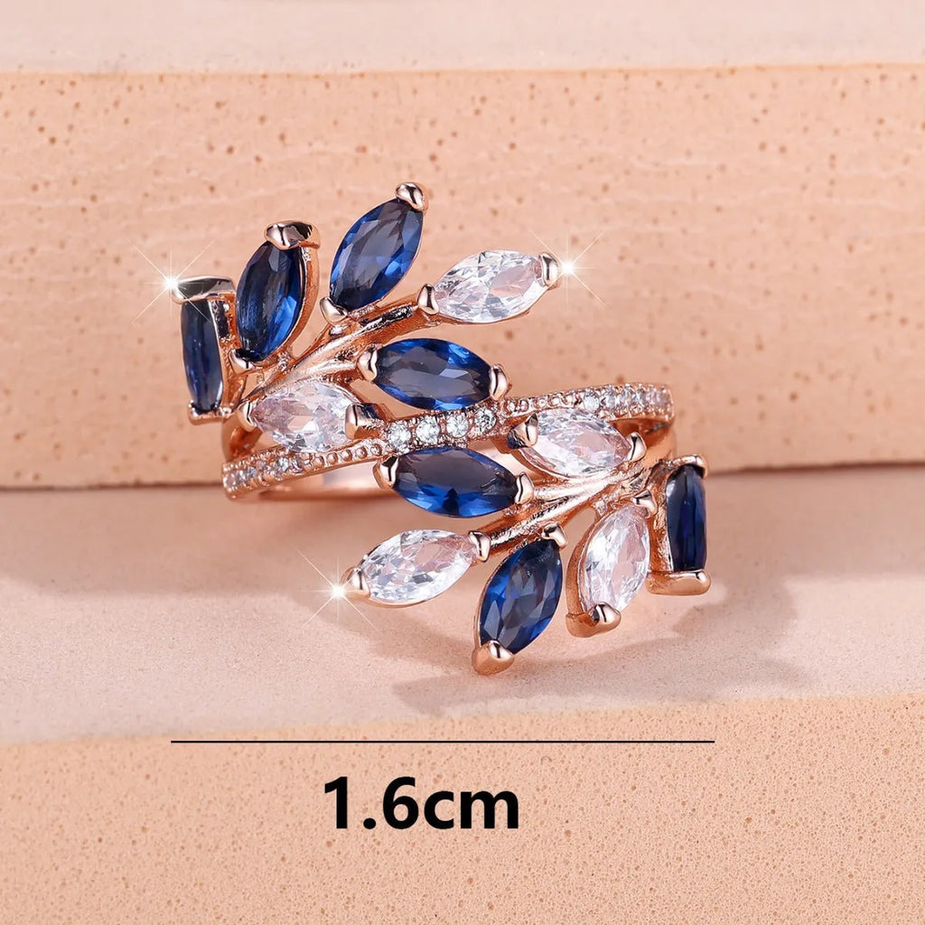 Adjustable copper leaf-shaped ring with a Horse Eye Zircon stone, shown in a rose gold finish.