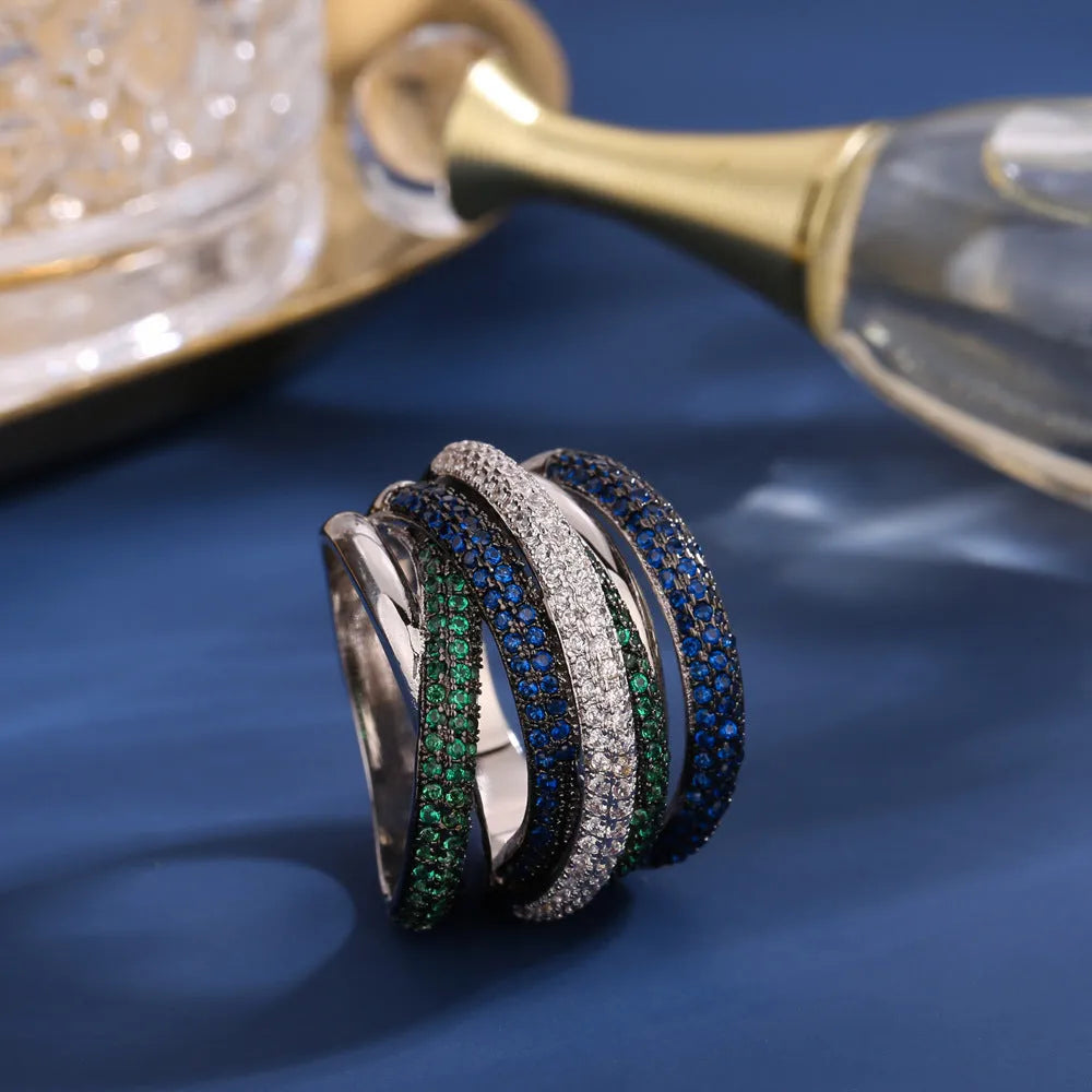 Women's geometric cross line ring with colour-separated zirconia stones in green, red, yellow, purple on a copper band