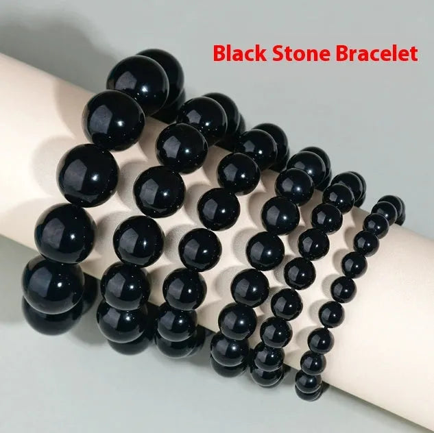 Hand-woven round obsidian crystal bracelet for couples on wrist, showing ethnic style and adjustable fit.