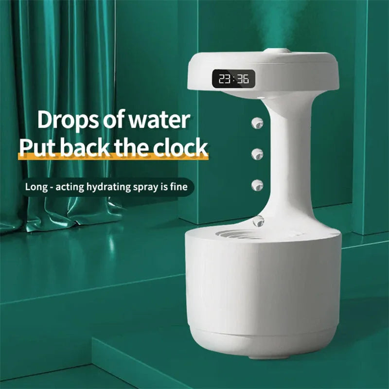 White anti-gravity humidifier with LED clock display emitting mist on a wooden desk.