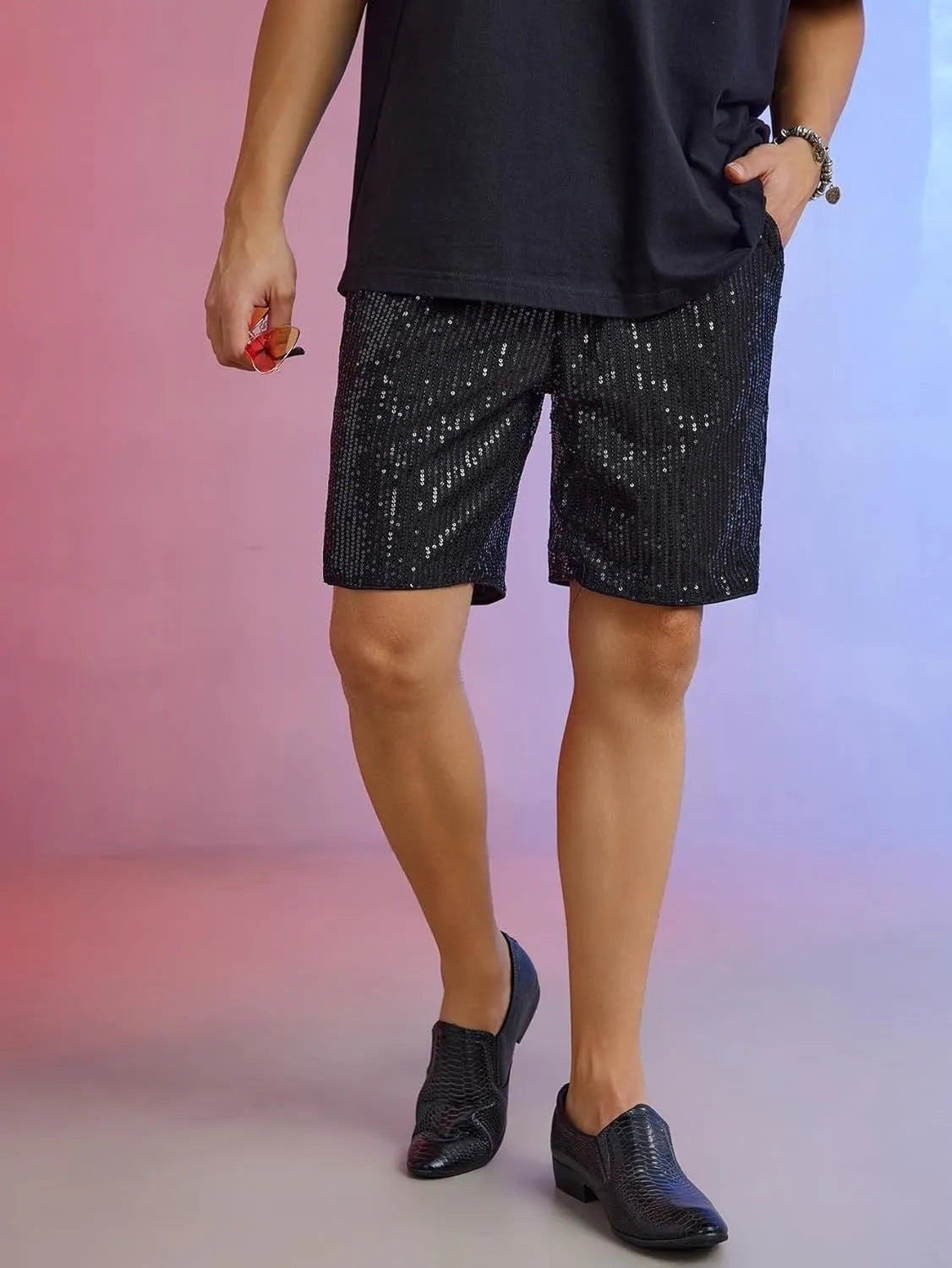 Men's silver sequin shorts with straight fit design and elastic waistband shown on hanger