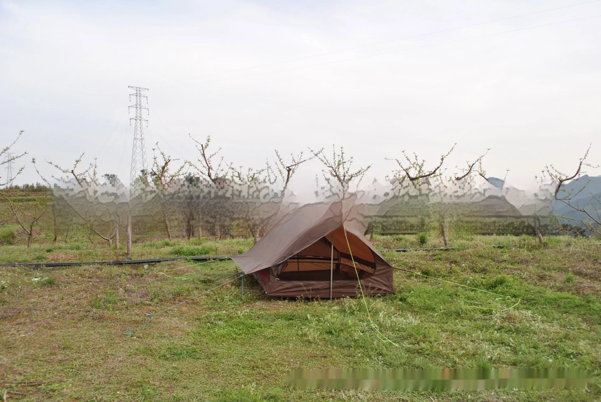 Brown A-line pole-free tent erected with hiking canes showing 2-3 person capacity and waterproof fabric construction