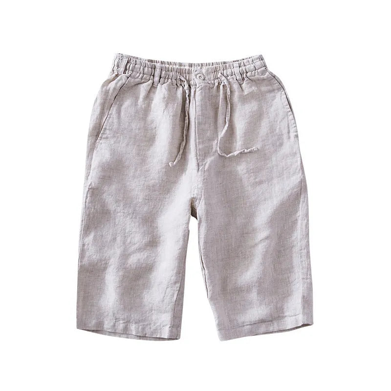 Men's loose-fitting linen capri pants in a light colour, showing the straight-leg style.