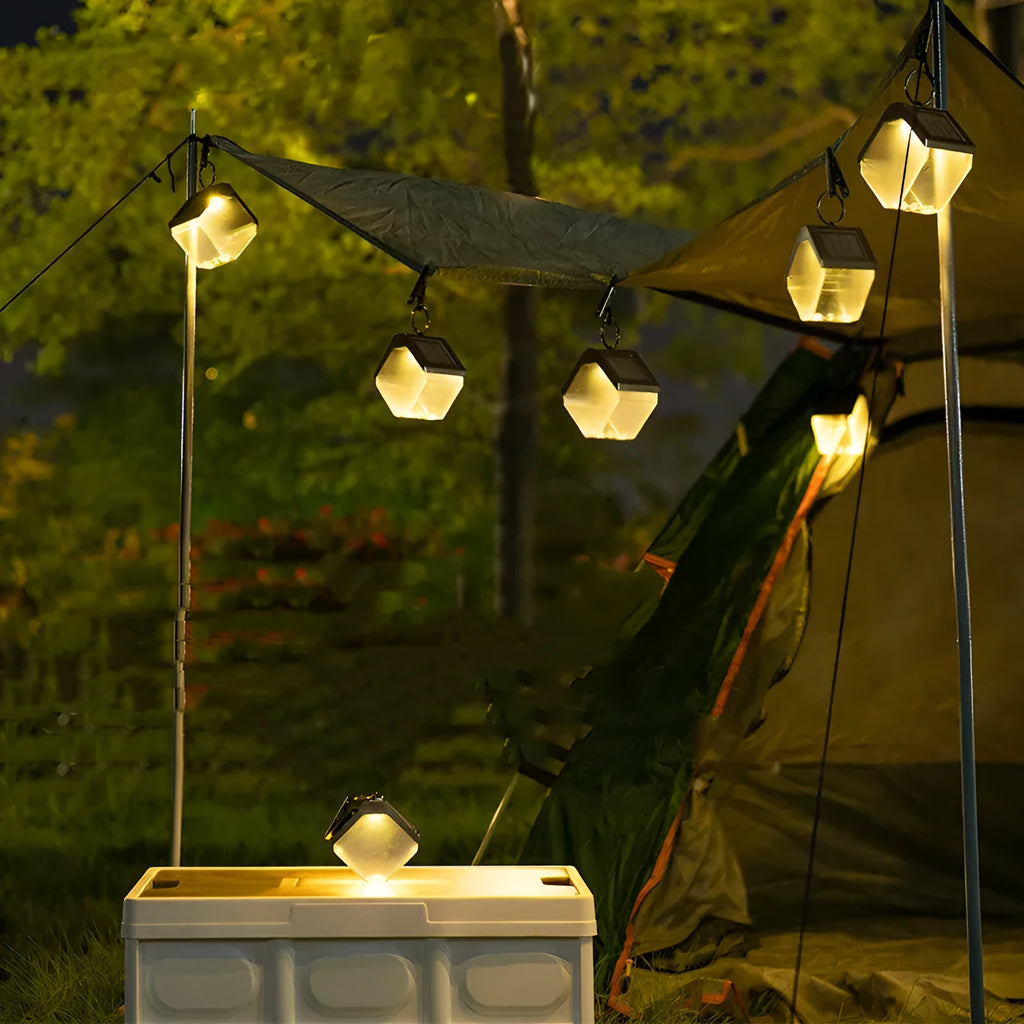 Outdoor solar ice brick chandelier with dual colour LED warm and colour light hanging in a garden