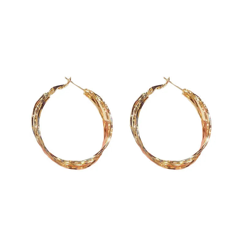 Simple metal twisted earrings for women, copper geometric round shape, available in gold or silver finish