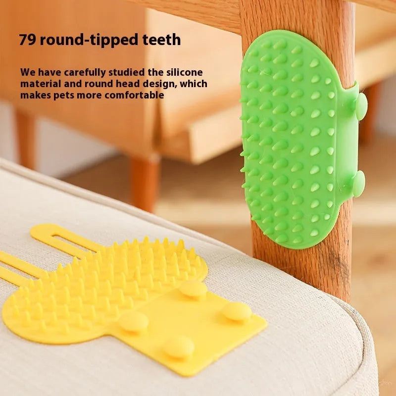 Black silicone cat grooming comb with rounded teeth and adjustable mounting strap for table legs.