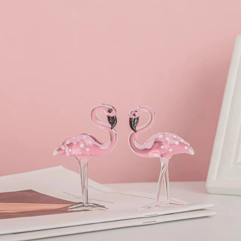 Pink crystal simulation flamingo decorative ornament on a table for home decor or gifting.