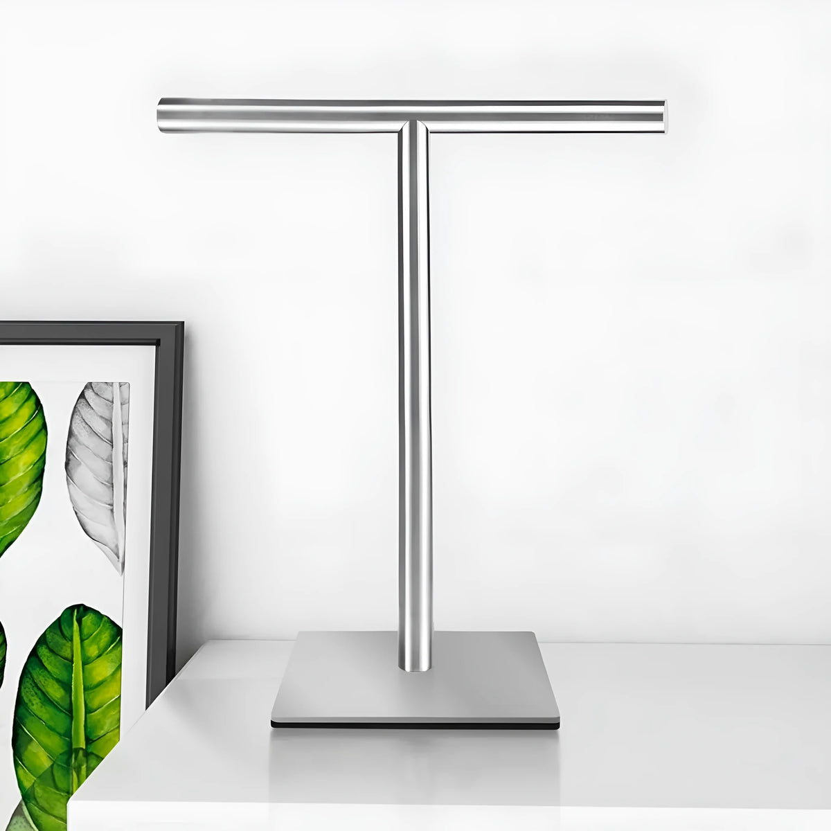 Single layer stainless steel vertical towel bar with square bottom, shown in black or silver for bathroom and toilet use