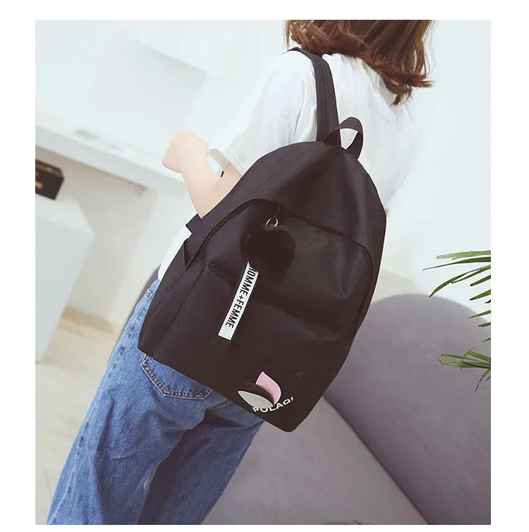 Canvas college schoolbag with leaves pattern showing anti-theft features and adjustable shoulder straps