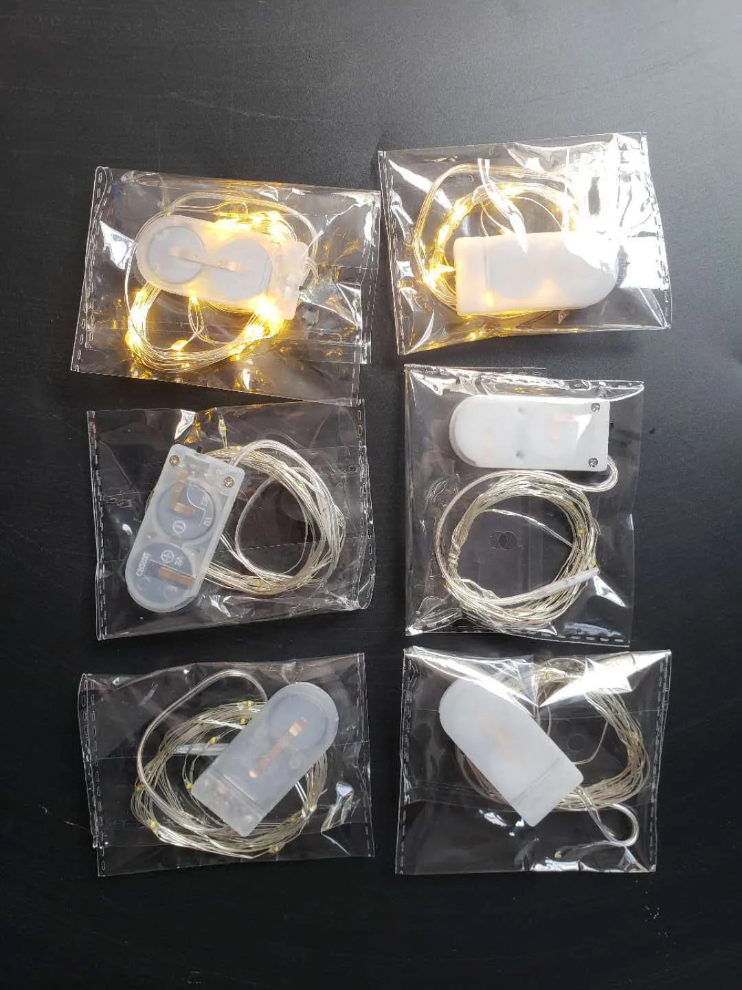 Copper wire LED button light string with battery box, shown in warm white and white light options.