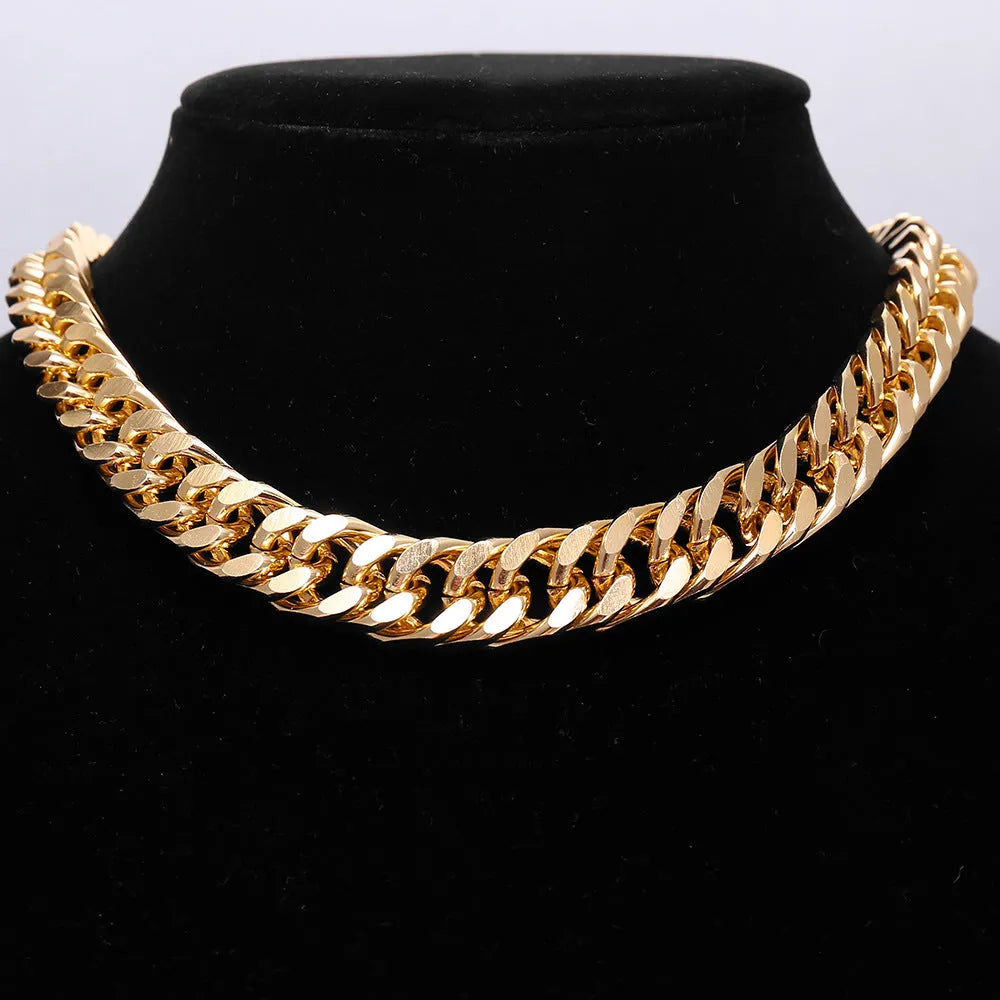 Gold-coloured thick chain necklace for women on a plain background