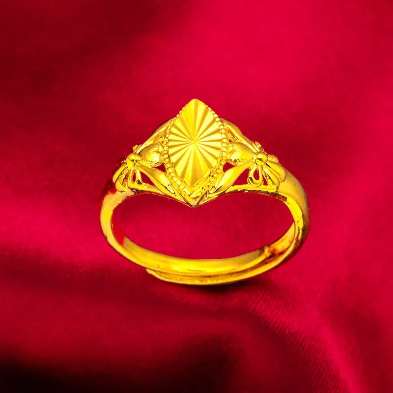 Gold-coloured brass ring with geometric open diamond flower pattern and textured surface