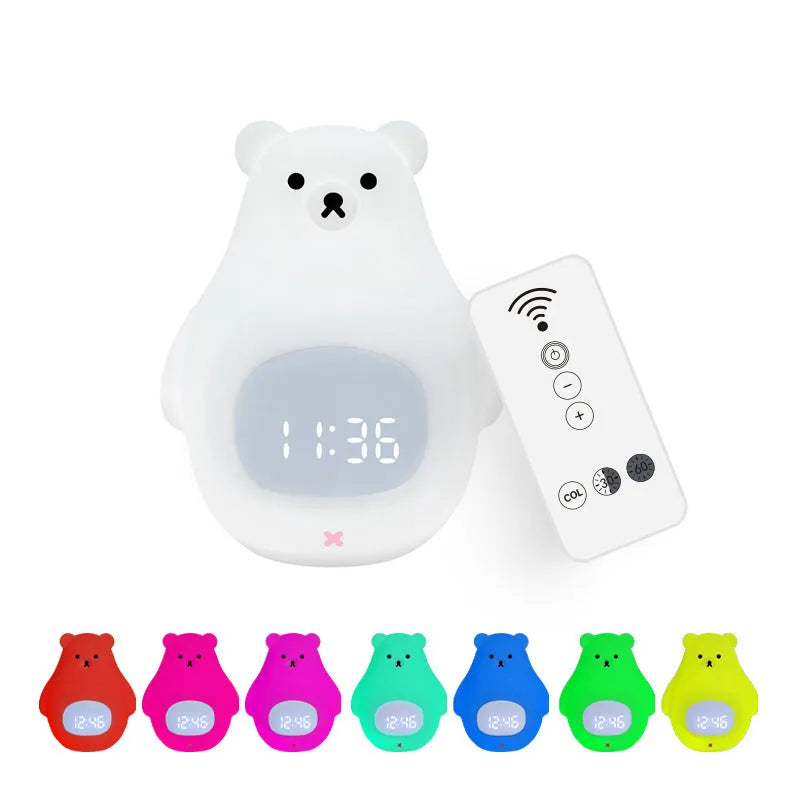 White silicone cartoon bear-shaped night light with remote control on a bedside table.