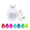 White silicone cartoon bear-shaped night light with remote control on a bedside table.