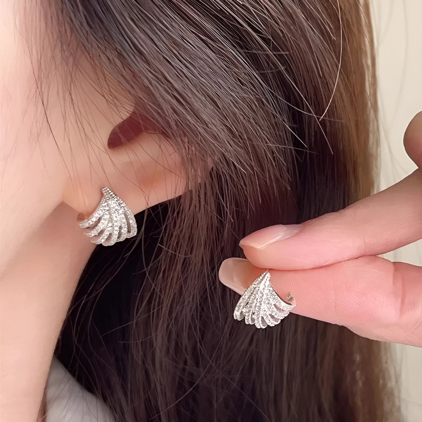 A pair of women's geometric design zircon earrings with a platinum colour electroplated finish.