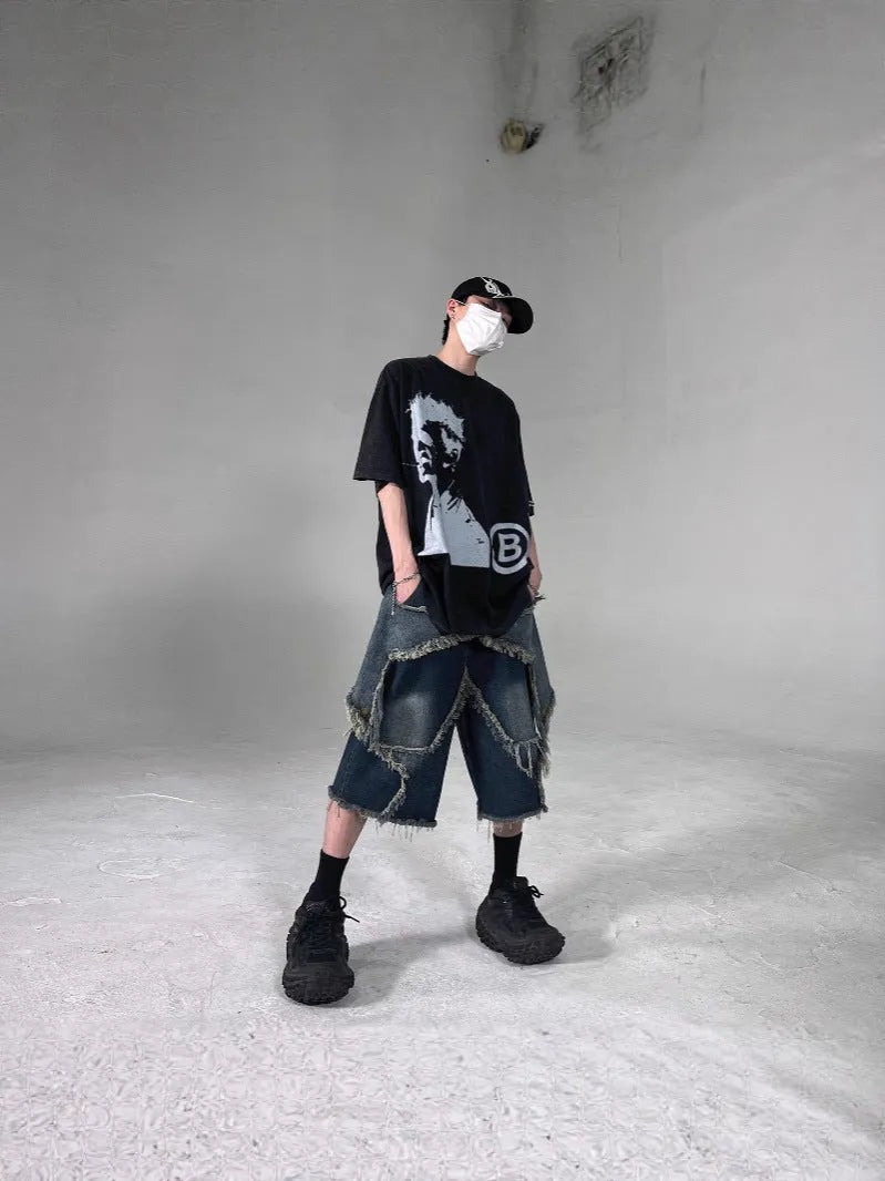 Blue men's loose-fit denim shorts with a frayed five-pointed star design on the leg.