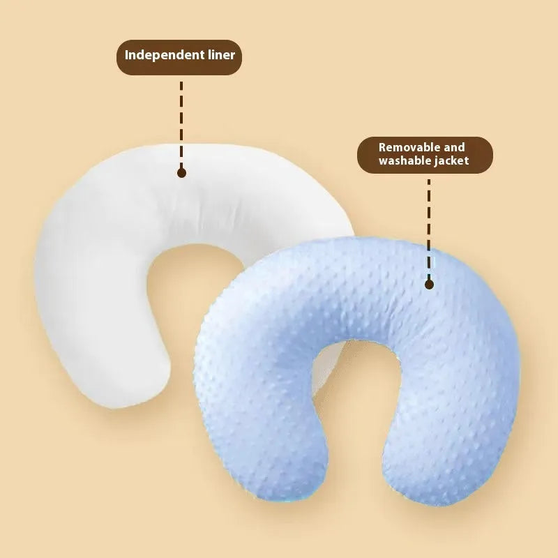 Grey multifunctional nursing pillow with milk spill prevention design on a neutral background