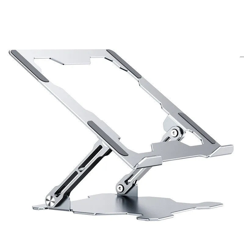 Grey aluminium laptop stand folded flat next to an open laptop, showing its adjustable angle and hollow design.