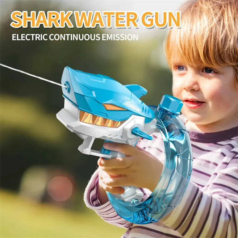 Blue Shark-shaped electric water gun toy with large tank on a summer beach.
