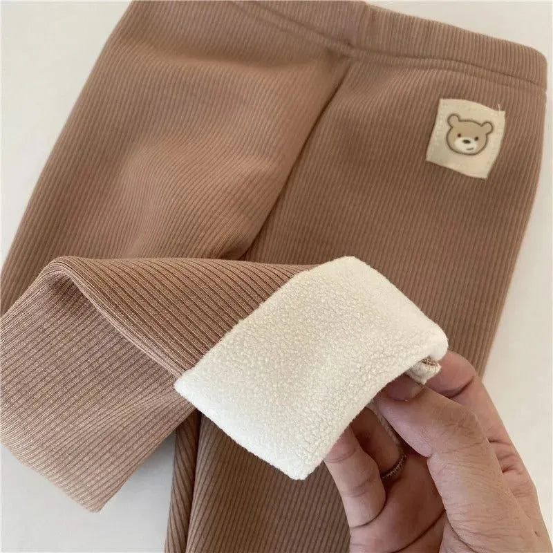 Girls' high-waist fleece-lined leggings in beige, shown with elastic hairband belt detail.