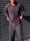 Black men's pleated long-sleeved polyester top showing vertical texture detail