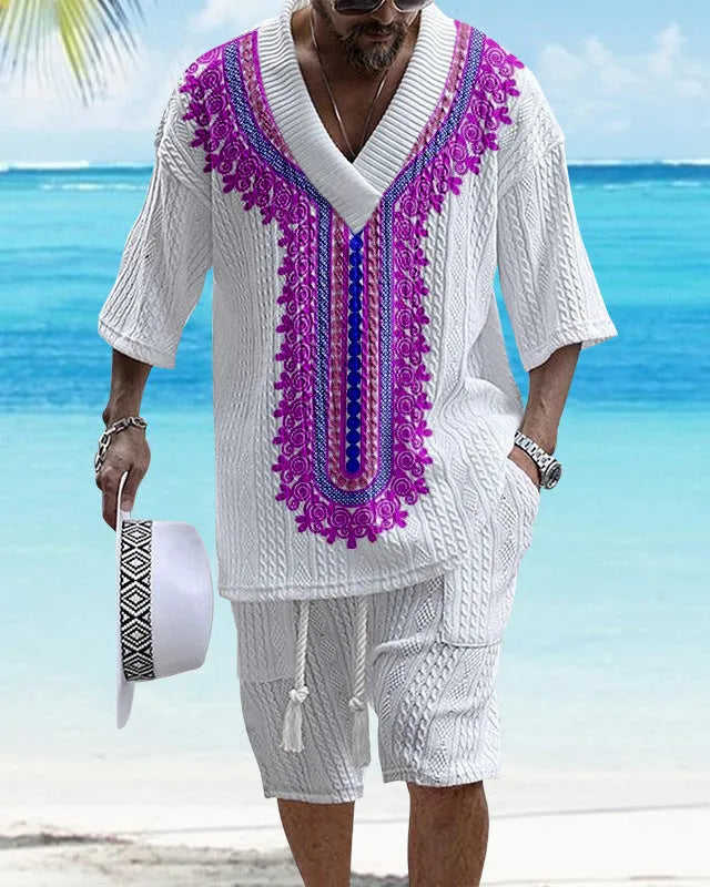 Man wearing a printed drop-shoulder knitted top and matching shorts from a casual summer suit.