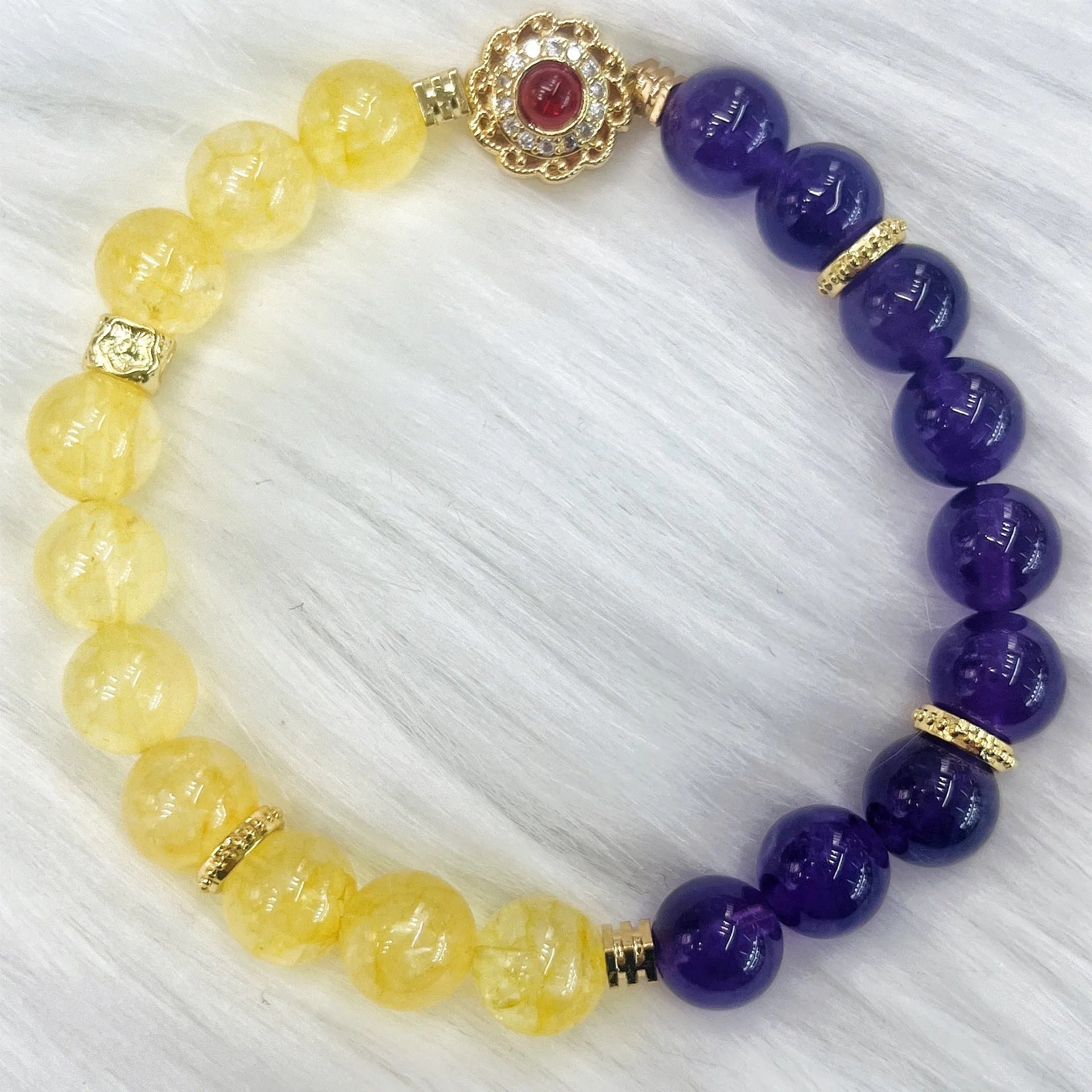 Handmade women's yellow and purple amethyst crystal bracelet showing manual craftsmanship detail