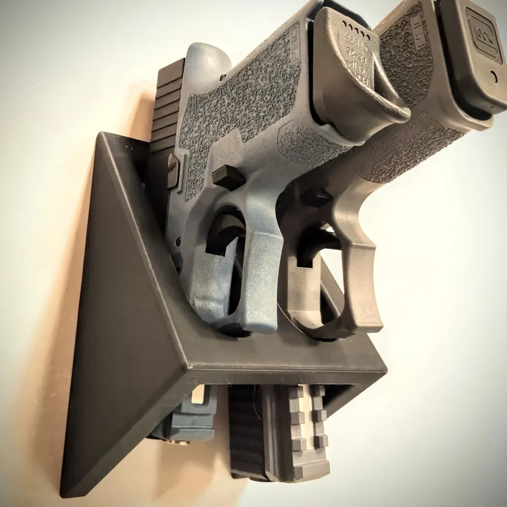 Black plastic punk-style pistol stand for displaying replica firearms.