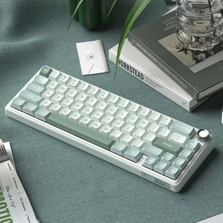 Wireless mechanical keyboard with RGB backlighting in various colour options on a desk.