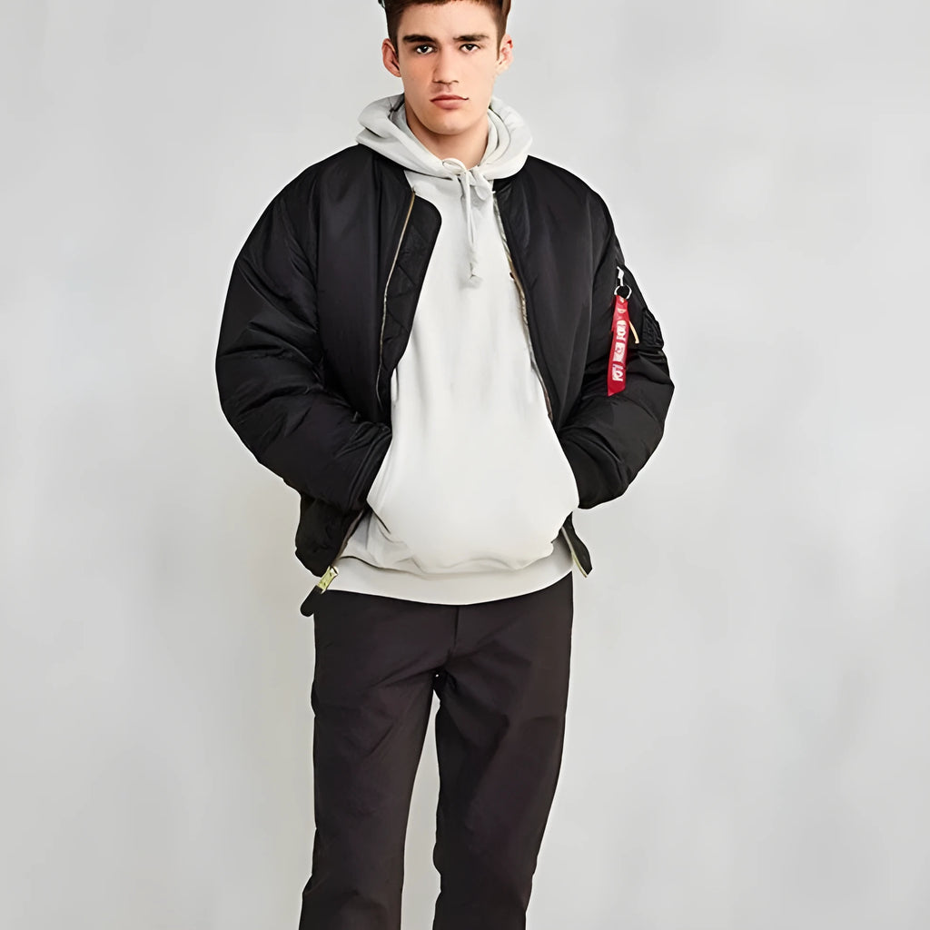 Men's reversible nylon pilot jacket in army green, shown on a model, displaying its loose fit and double-sided design.
