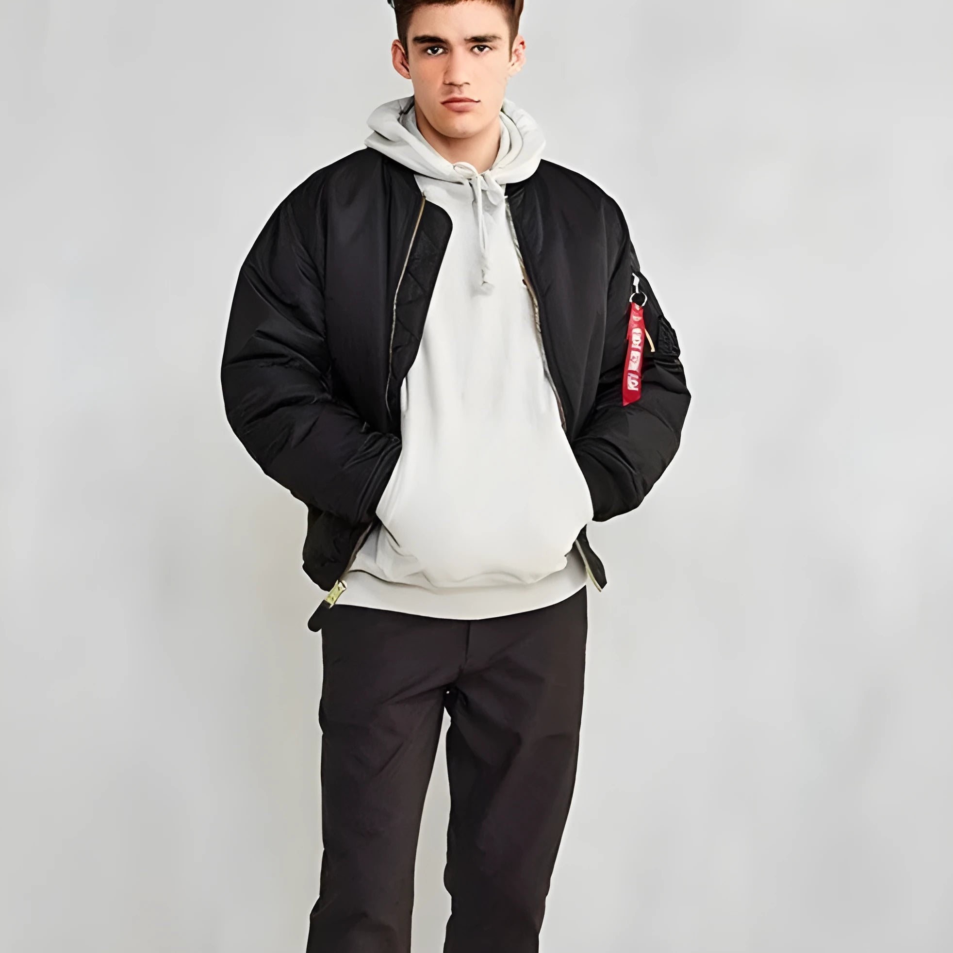 Men's reversible nylon pilot jacket in army green, shown on a model, displaying its loose fit and double-sided design.