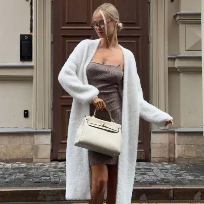 White loose-fit knitted cardigan jacket for women, shown with long sleeves.
