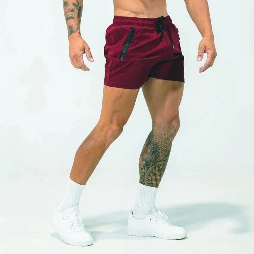 A man wearing blue quick-drying polyester sports shorts with a mid-waist design, suitable for casual summer and athletic activities.