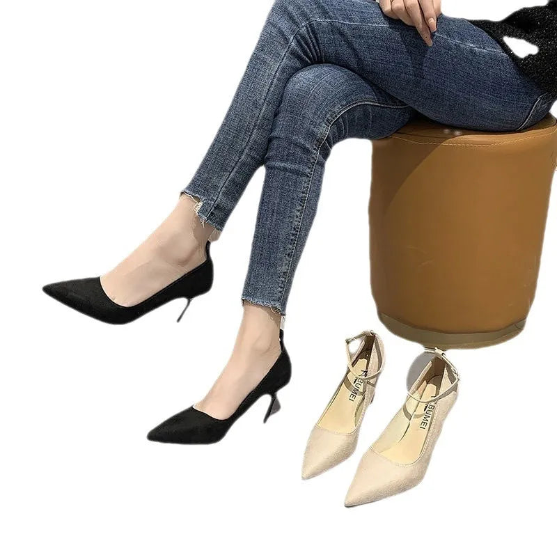 Women's black stiletto pump shoes with a silver buckle detail on the side.