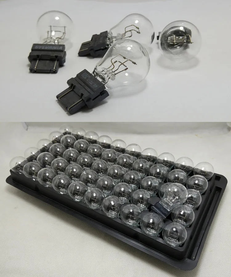 Wagner brake light bulb with yellow glass and dual wire connections for industrial equipment lighting