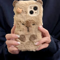 Brown furry plush capabala phone case for iPhone showing cartoon face and flannel texture