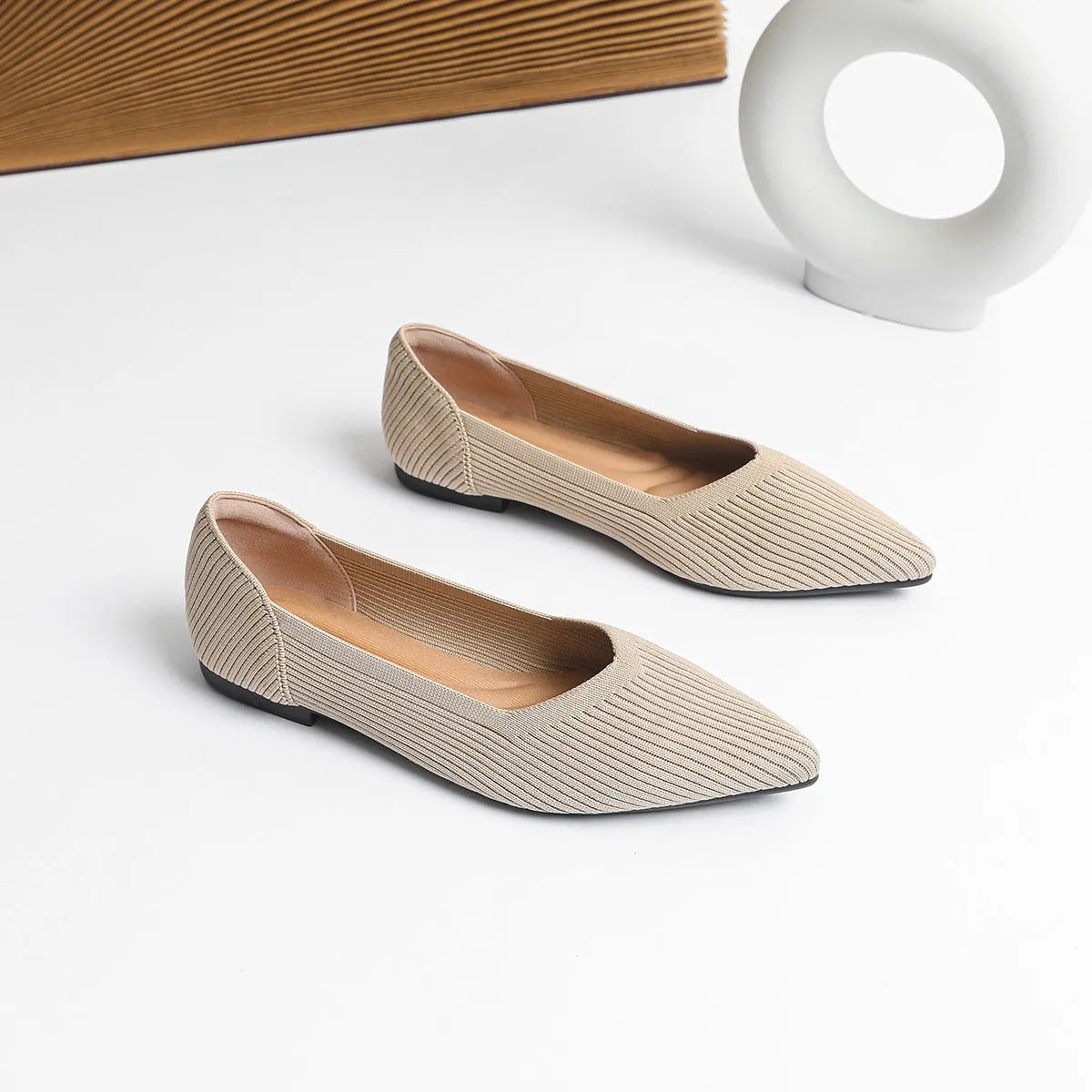Women's knit flat pumps with pointed toe and rubber sole available in multiple colours