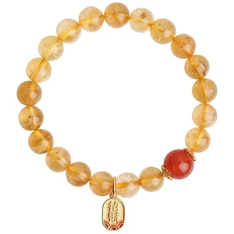 Polished natural red agate bead bracelet on a wrist, showing smooth beads.