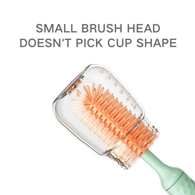 Pink and green electric rotating silicone bottle brush set for cleaning baby bottles and cups.