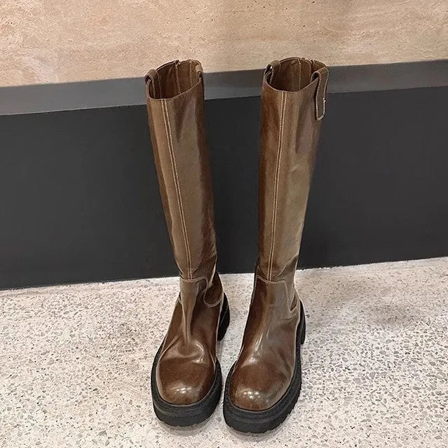 Women's black chunky heel knee-high knight boots with round toe and back zipper on a white background.