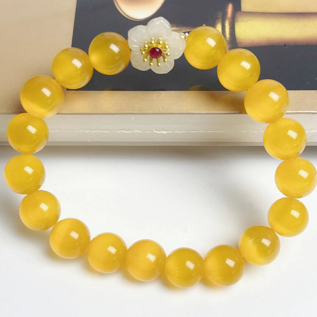 Handmade glass bead bracelet with floral design in yellow, pink, white, or green.