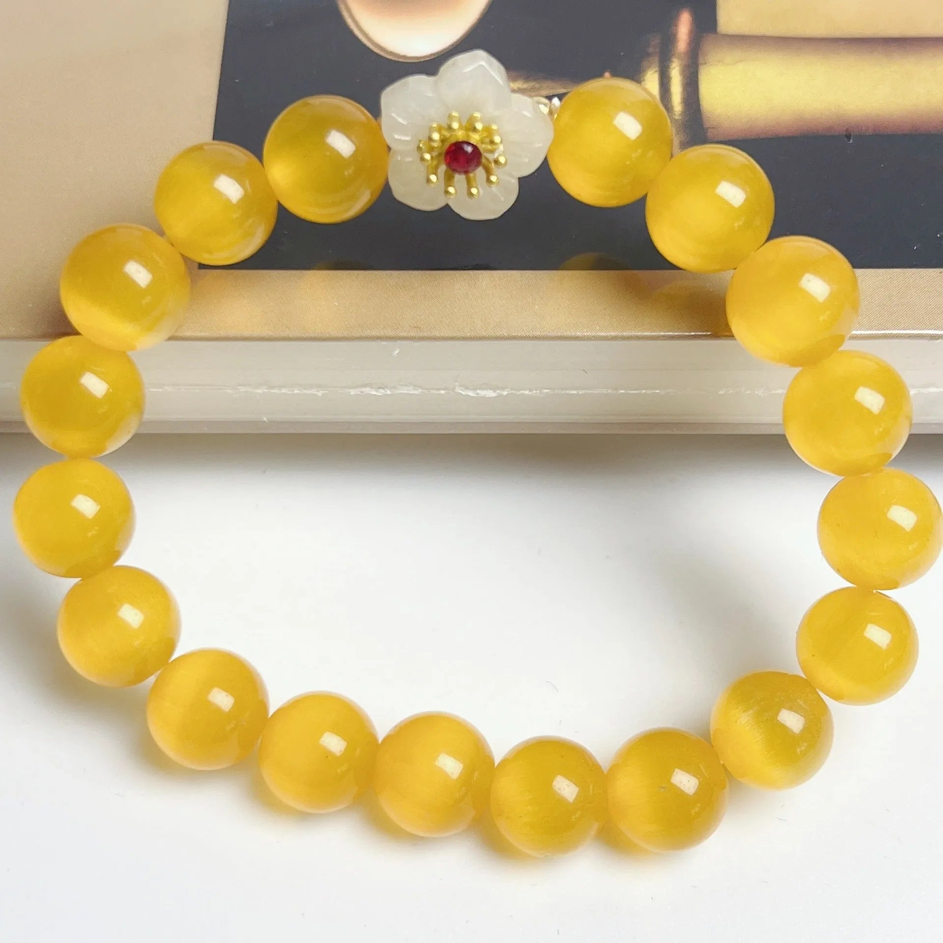 Handmade glass bead bracelet with floral design in yellow, pink, white, or green.