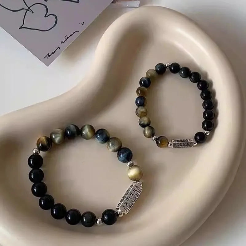 Sterling silver bracelet with obsidian and tigereye round beads featuring six words mantra Chinese design