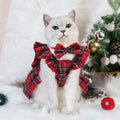 Red tartan Christmas skirt with bow tie and head flower on a dog, showing universal pet festive clothing.