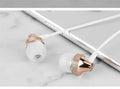 Gold metal in-ear headphones with a wheat-coloured cable and 3.5mm plug.