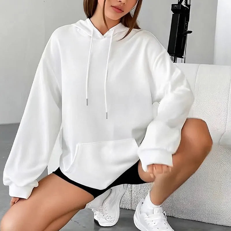 Women's loose fit grey hooded sweatshirt with front pocket and long sleeves on a hanger.